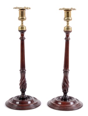 Lot 348 - A PAIR OF GEORGE III MAHOGANY CANDLESTICKS...