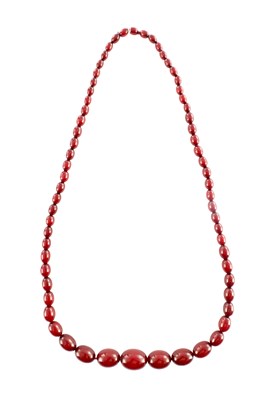 Lot 102 - A GRADUATED CHERRY AMBER OVAL BEAD NECKLACE