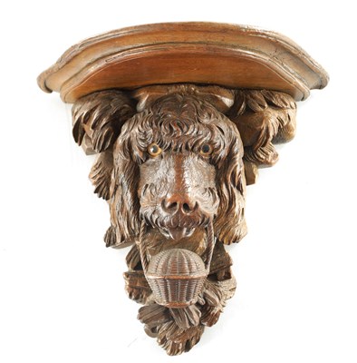Lot 939 - A 19TH CENTURY BLACK FOREST CARVED LINDEN WOOD HANGING BRACKET FORMED AS A DOGS HEAD