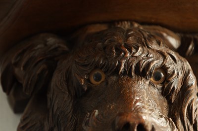 Lot 939 - A 19TH CENTURY BLACK FOREST CARVED LINDEN WOOD HANGING BRACKET FORMED AS A DOGS HEAD