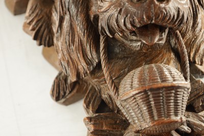 Lot 939 - A 19TH CENTURY BLACK FOREST CARVED LINDEN WOOD HANGING BRACKET FORMED AS A DOGS HEAD