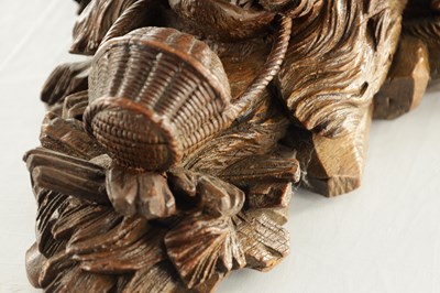 Lot 939 - A 19TH CENTURY BLACK FOREST CARVED LINDEN WOOD HANGING BRACKET FORMED AS A DOGS HEAD