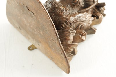 Lot 939 - A 19TH CENTURY BLACK FOREST CARVED LINDEN WOOD HANGING BRACKET FORMED AS A DOGS HEAD