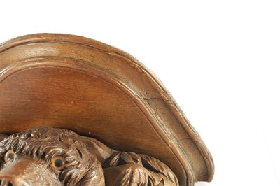 Lot 939 - A 19TH CENTURY BLACK FOREST CARVED LINDEN WOOD HANGING BRACKET FORMED AS A DOGS HEAD
