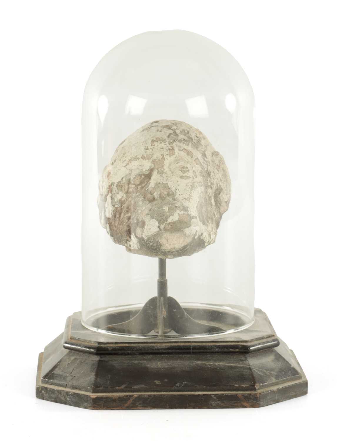 Lot 341 - AN EARLY CARVED STONE HEAD UNDER GLASS DOME