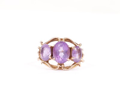 Lot 237 - A 9CT GOLD AMETHYST THREE-STONE RING