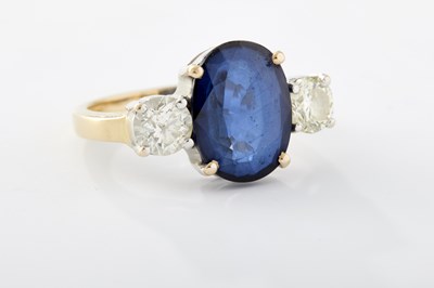 Lot 248 - A 20TH CENTURY 18CT GOLD SAPPHIRE AND DIAMOND THREE-STONE RING
