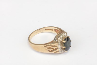 Lot 287 - A 9CT GOLD SAPPHIRE AND DIAMOND HALO RING