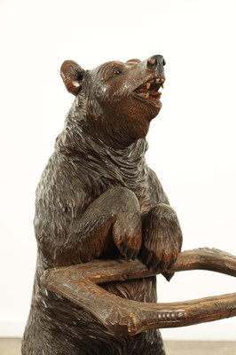 Lot 711 - A LATE 19TH CENTURY BLACK FOREST CARVED BEAR STICK STAND