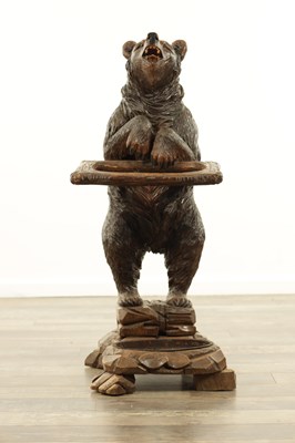 Lot 711 - A LATE 19TH CENTURY BLACK FOREST CARVED BEAR STICK STAND