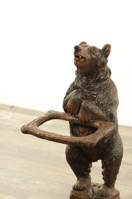Lot 711 - A LATE 19TH CENTURY BLACK FOREST CARVED BEAR STICK STAND