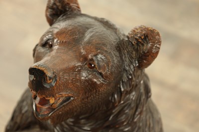 Lot 711 - A LATE 19TH CENTURY BLACK FOREST CARVED BEAR STICK STAND