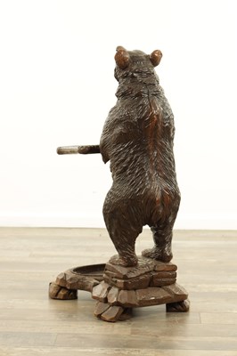 Lot 711 - A LATE 19TH CENTURY BLACK FOREST CARVED BEAR STICK STAND