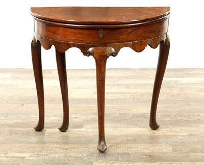 Lot 1265 - A GEORGE II MAHOGANY DEMI LUNE TEA TABLE