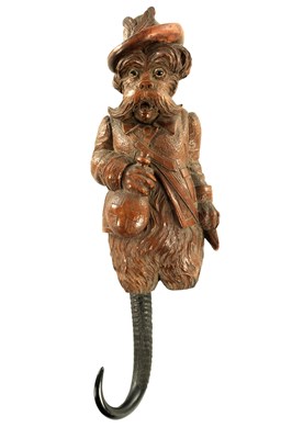 Lot 749 - A LATE 19TH CENTURY BLACK FOREST CARVED WOOD COAT HOOK
