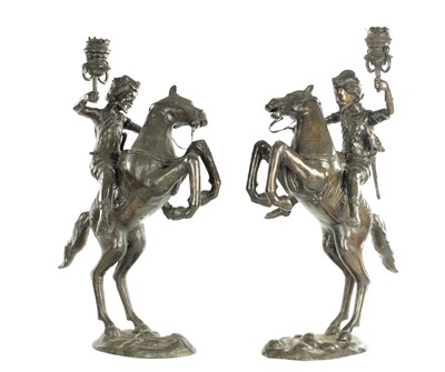 Lot 577 - A PAIR OF EARLY 20TH CENTURY PATINATED BRONZE EQUESTRIAN FIGURAL TORCHERES