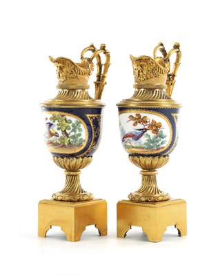 Lot 562 - A PAIR OF 19TH CENTURY FRENCH SEVRES PORCELAIN AND ORMOLU EWERS