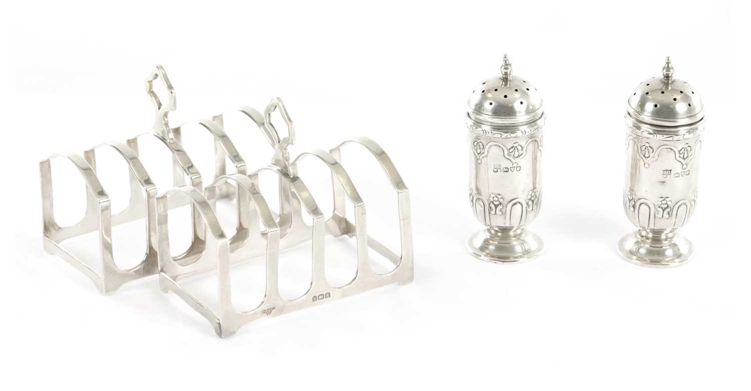 Lot 4 - A PAIR OF SMALL SILVER TOAST RACKS TOGETHER WITH A PAIR OF SILVER PEPPERETTES