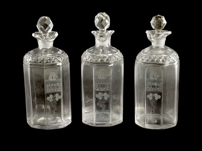Lot 373 - A SET OF THREE GEORGIAN CUT GLASS DECANTERS