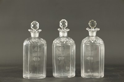 Lot 373 - A SET OF THREE GEORGIAN CUT GLASS DECANTERS