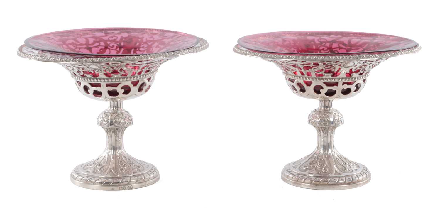 Lot 458 - JOHN SAMUEL HUNT, LONDON. A PAIR OF VICTORIAN SILVER AND RUBY GLASS TAZZAS