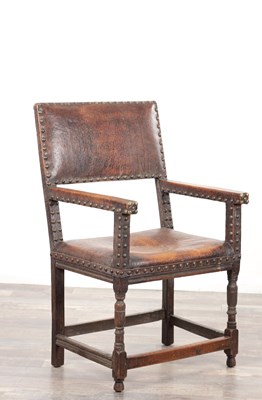 Lot 1242 - A 17TH CENTURY OAK FRAMED LEATHER UPHOLSTERED ARM CHAIR