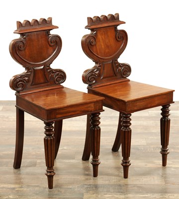 Lot 1169 - AN UNUSUAL PAIR OF REGENCY FIGURED MAHOGONY HALL CHAIRS IN THE MANNER OF GILLOWS