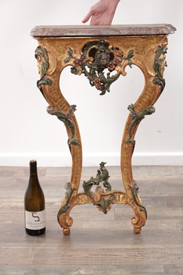 Lot 1201 - AN 18TH CENTURY ITALIAN CARVED GILTWOOD AND POLYCHROME DECORATED CONSOLE TABLE OF SMALL SIZE