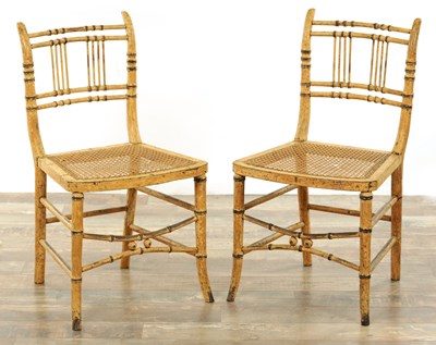 Lot 1261 - A PAIR OF REGENCY PAINTED BERGERE SIDE CHAIRS