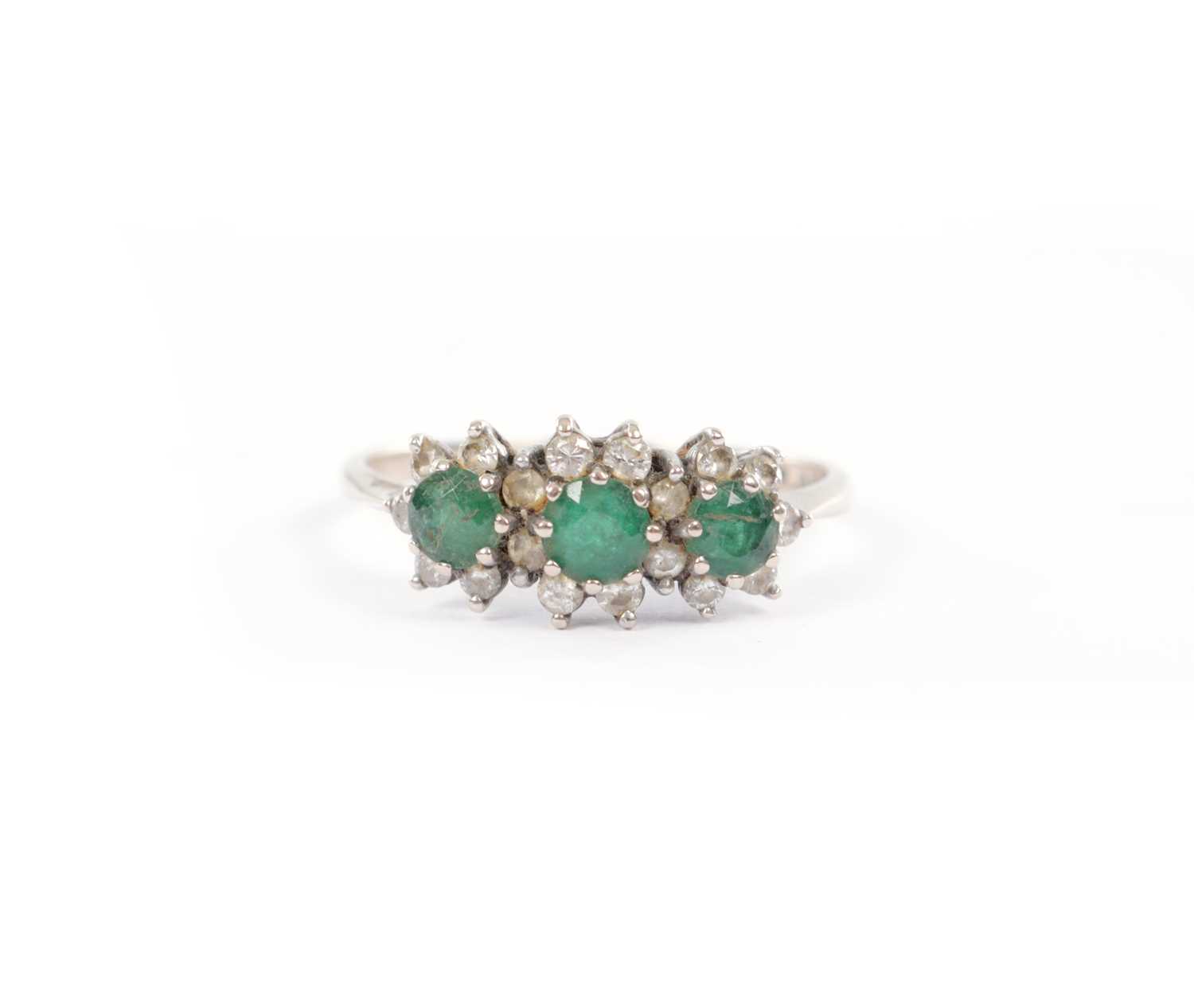 Lot 261 - A VICTORIAN 18CT WHITE GOLD THREE-STONE EMERALD AND DIAMOND CLUSTER RING
