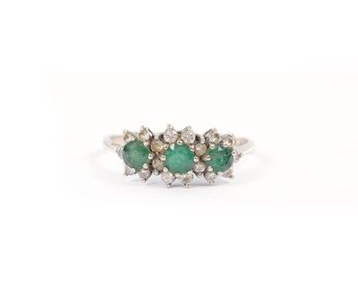 Lot 261 - A VICTORIAN 18CT WHITE GOLD THREE-STONE EMERALD AND DIAMOND CLUSTER RING