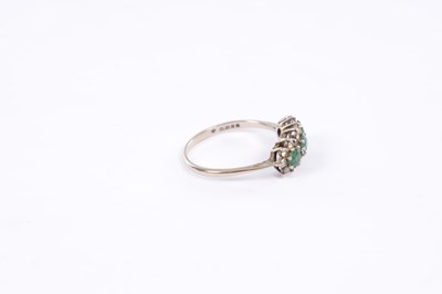 Lot 261 - A VICTORIAN 18CT WHITE GOLD THREE-STONE EMERALD AND DIAMOND CLUSTER RING