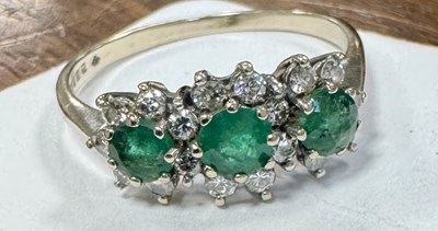 Lot 261 - A VICTORIAN 18CT WHITE GOLD THREE-STONE EMERALD AND DIAMOND CLUSTER RING