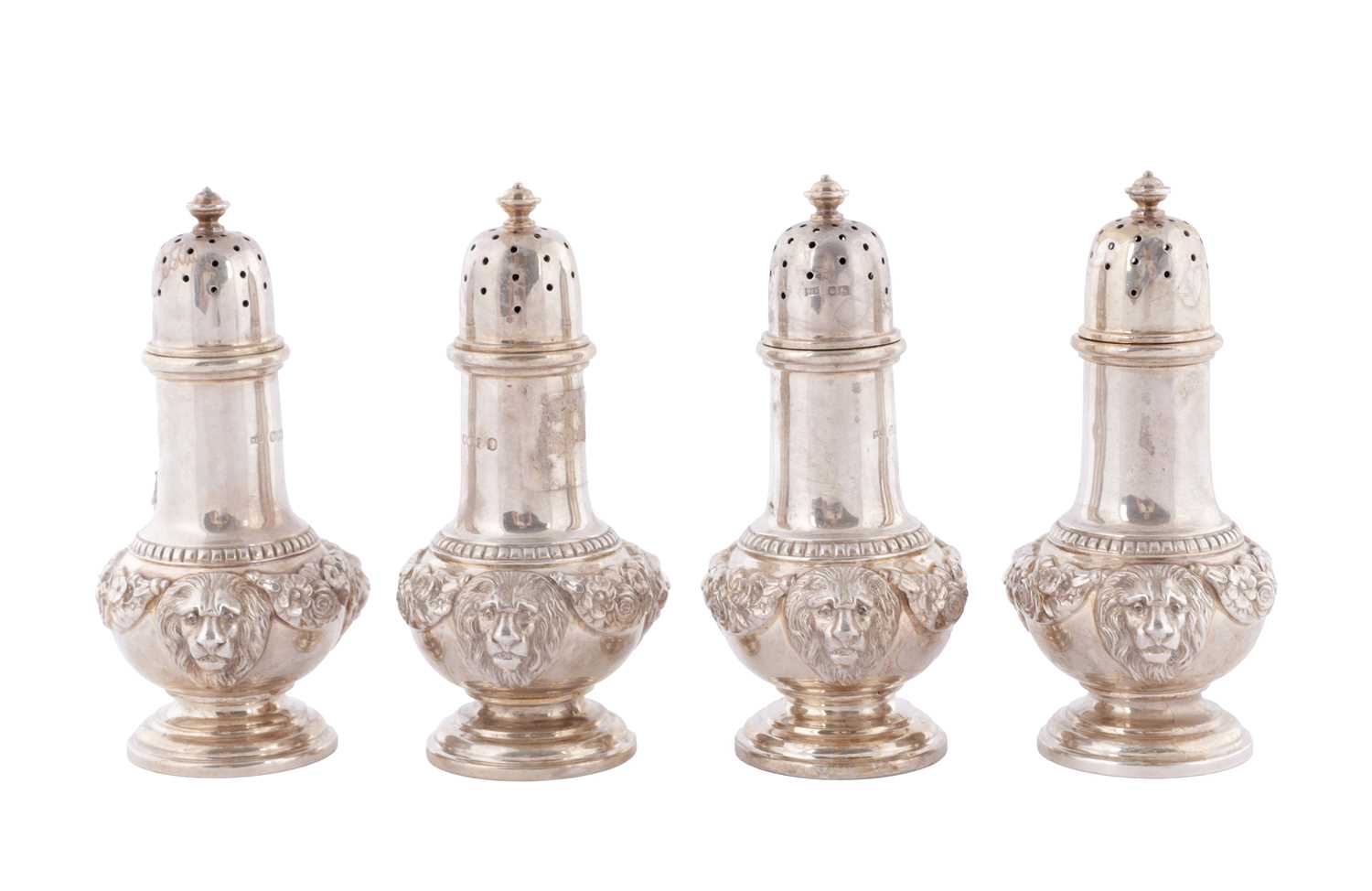 Lot 451 - A SET OF FOUR GEORGE V CAST SILVER PEPPERS