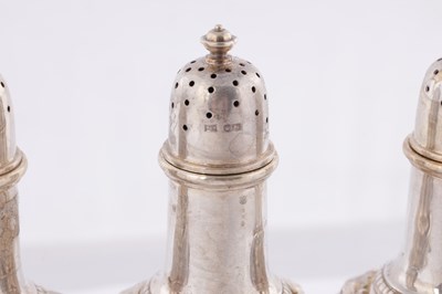 Lot 451 - A SET OF FOUR GEORGE V CAST SILVER PEPPERS