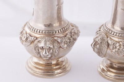 Lot 451 - A SET OF FOUR GEORGE V CAST SILVER PEPPERS