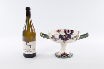 Lot 22 - AN EARLY 20TH CENTURY MOORCROFT TWO HANDLED FOOTED BOWL