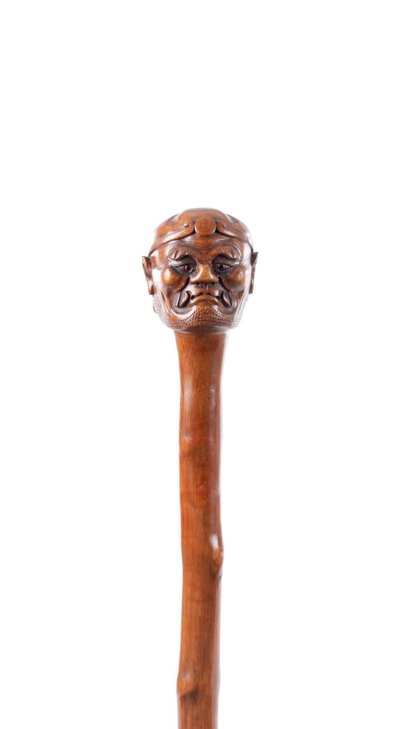 Lot 48 - AN ORIENTAL 19TH CENTURY CARVED WOOD WALKING STICK
