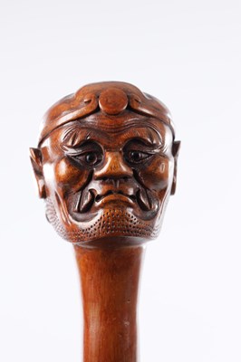 Lot 48 - AN ORIENTAL 19TH CENTURY CARVED WOOD WALKING STICK
