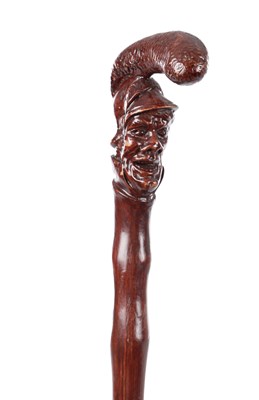 Lot 338 - A 20TH CENTURYCARVED AND PAINTED GROTESQUE HANDLED WALKING STICK