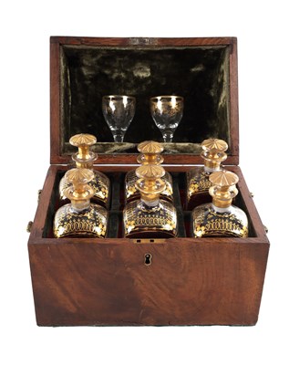 Lot 706 - A GEORGE III MAHOGANY SIX BOTTLE TANTALUS