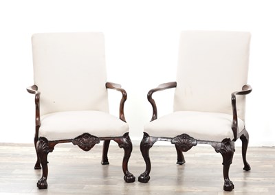 Lot 1213 - A PAIR OF GEORGE II STYLE CARVED WALNUT ARMCHAIRS IN THE MANNER OF JAMES MOORE