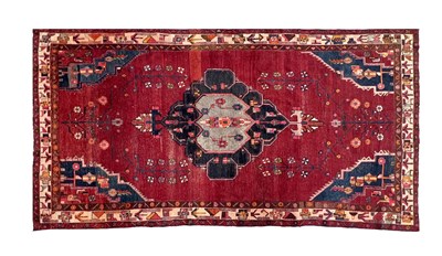 Lot 516 - AN ANTIQUE PERSIAN RUG