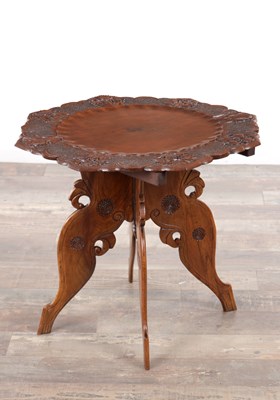 Lot 108 - A 19TH CENTURY ANGLO-INDIAN CARVED HARDWOOD FOLDING SIDE TABLE