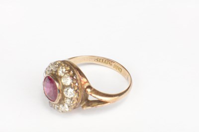 Lot 257 - A RUBY AND DIAMOND 9CT GOLD CLUSTER RING