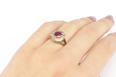 Lot 257 - A RUBY AND DIAMOND 9CT GOLD CLUSTER RING
