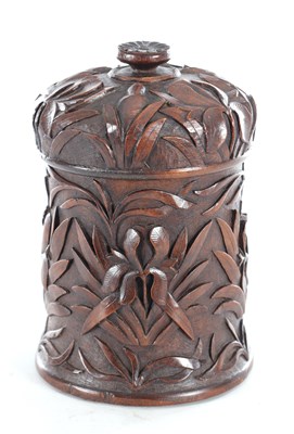 Lot 727 - A 19TH CENTURY CARVED OAK TABACO JAR
