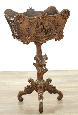 Lot 754 - A 19TH CENTURY BLACK FOREST CARVED WALNUT JARDINERE STAND WITH DEER AND SQUIRREL TO THE BASE