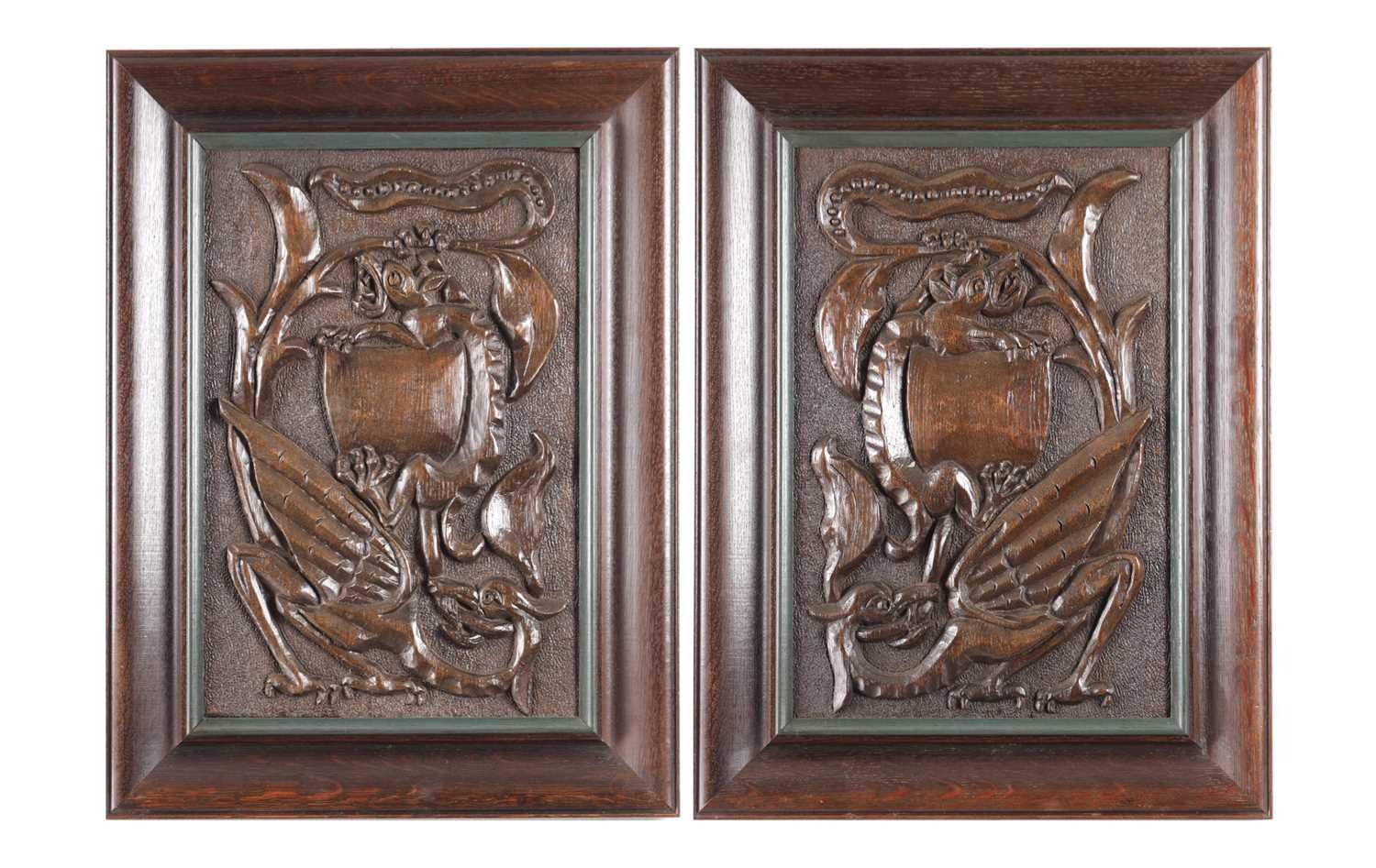 Lot 743 - A PAIR OF ARTS AND CRAFTS CARVED OAK HANGING PANELS