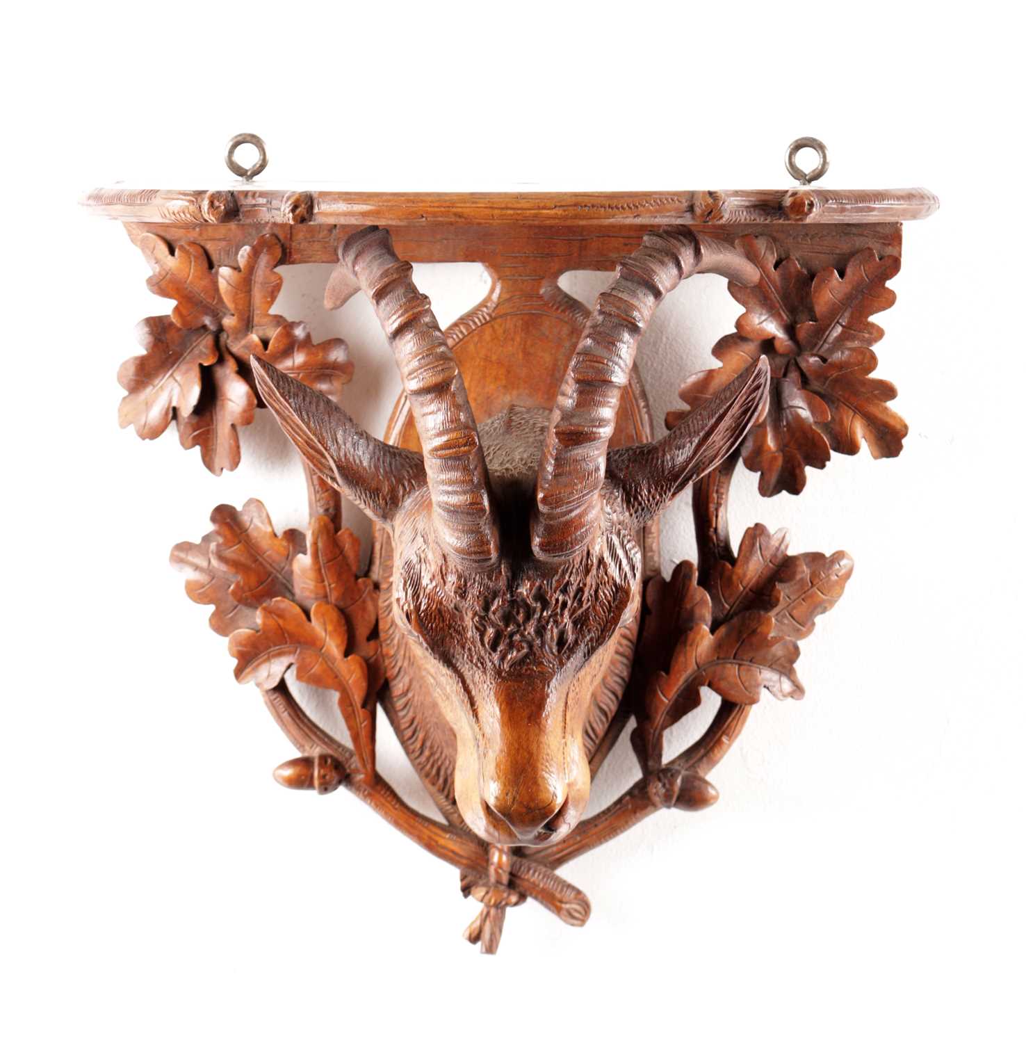 Lot 719 - A 19TH CENTURY CARVED WALNUT BLACK FOREST WALL BRACKET